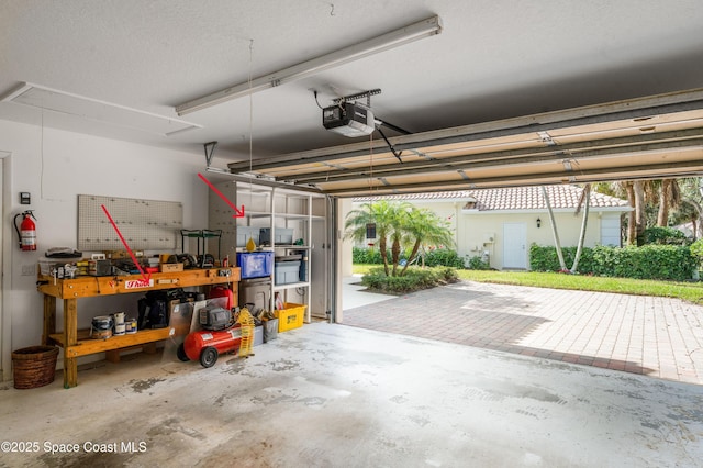 garage featuring a workshop area and a garage door opener