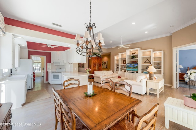 dining room with ceiling fan with notable chandelier, light hardwood / wood-style floors, crown molding, and sink