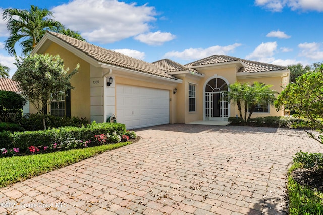 mediterranean / spanish home featuring a garage