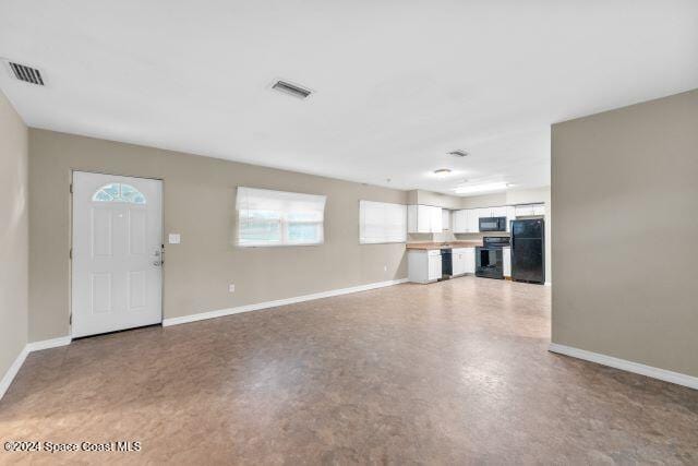 unfurnished living room with a wealth of natural light