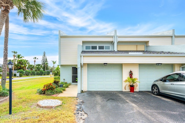 view of front of house with a garage and a front yard