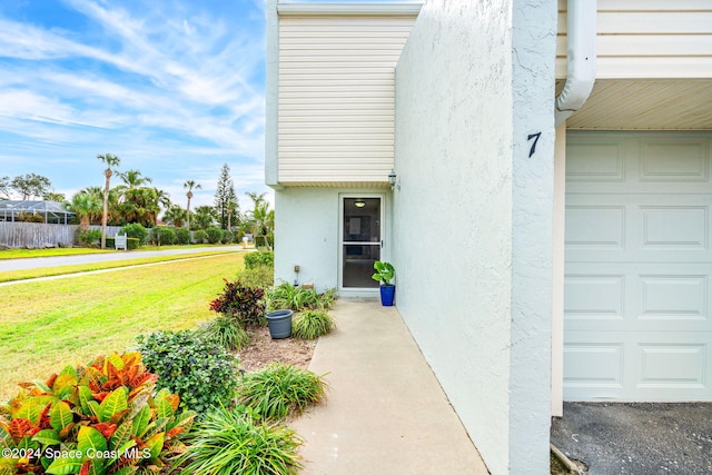 doorway to property featuring a lawn