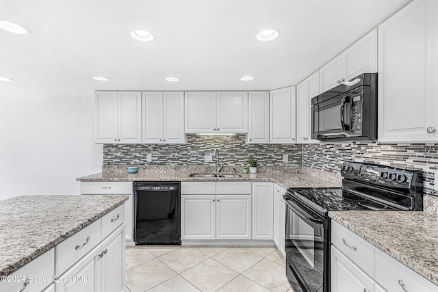 kitchen featuring sink, white cabinets, and black appliances