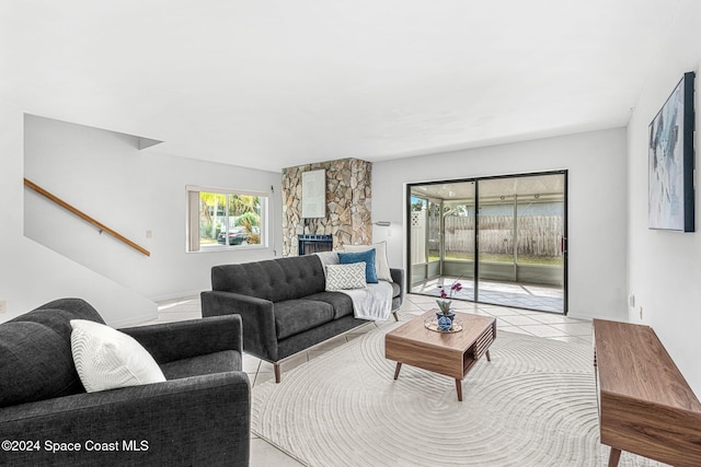 living room featuring a fireplace and light tile patterned floors