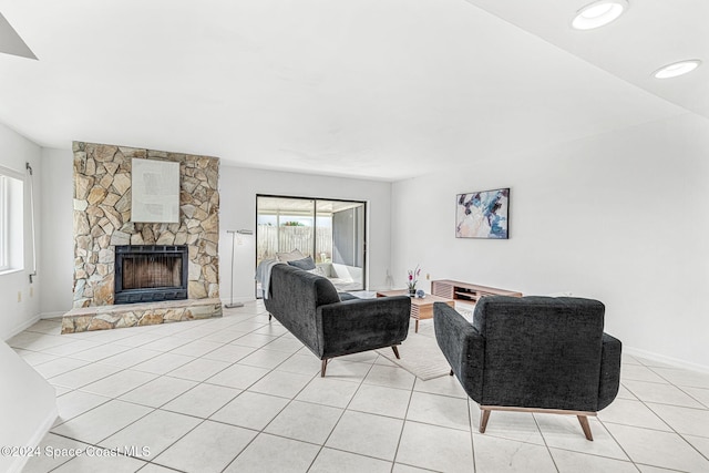 living room with a fireplace and light tile patterned floors