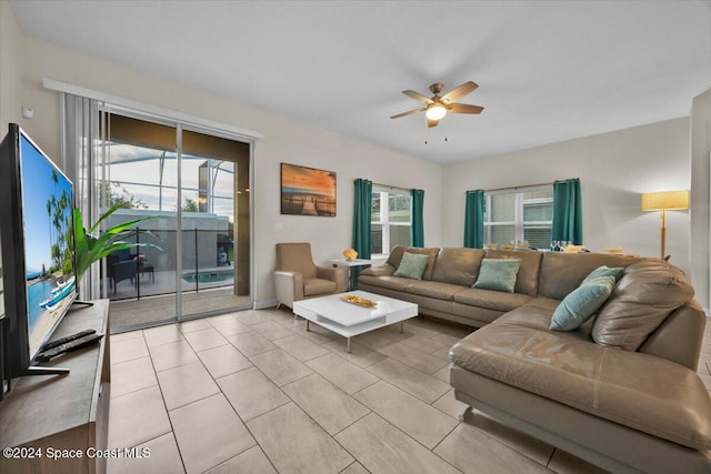 tiled living room with ceiling fan and a healthy amount of sunlight