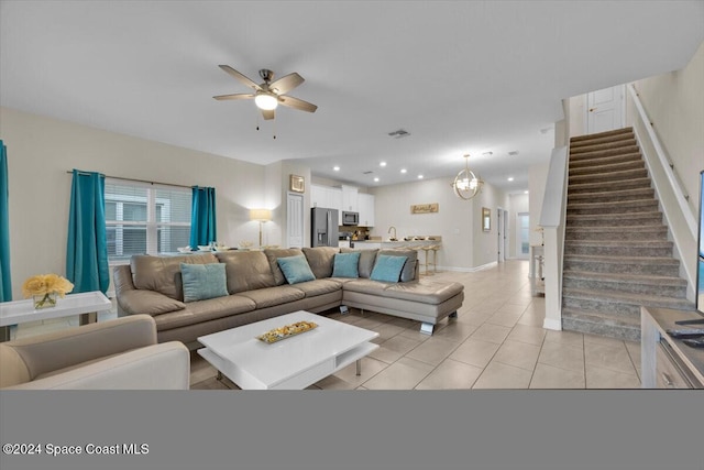 living room featuring ceiling fan and light tile patterned floors