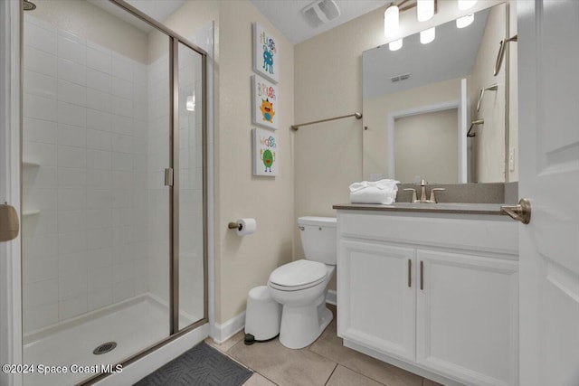 bathroom with toilet, vanity, tile patterned floors, and an enclosed shower