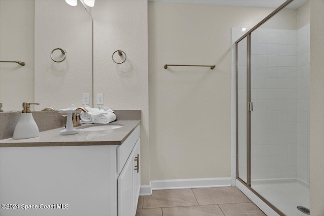 bathroom featuring tile patterned flooring, vanity, and a shower with shower door