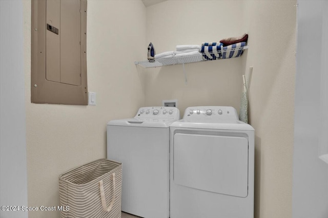 washroom featuring washing machine and dryer and electric panel