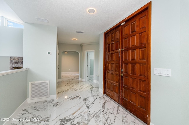 hallway featuring a textured ceiling