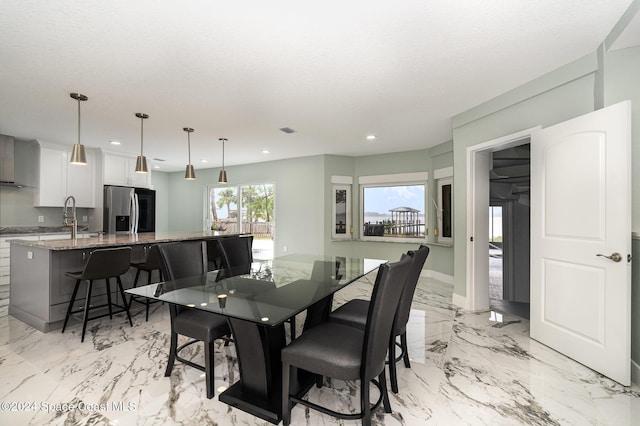 dining room featuring a textured ceiling and sink