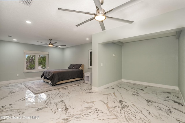 bedroom featuring ceiling fan and a textured ceiling