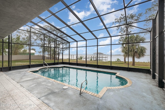 view of pool with glass enclosure and a patio