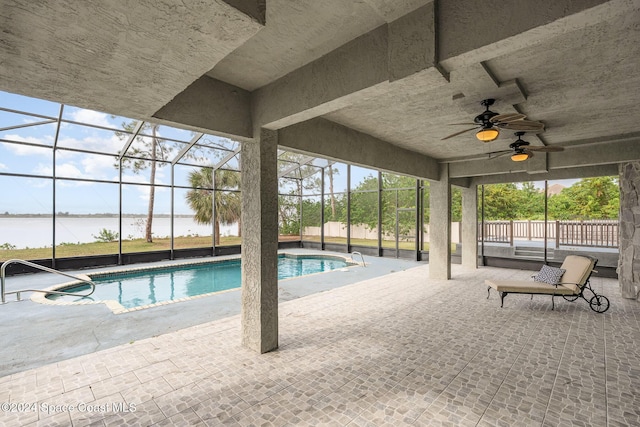 view of swimming pool with a water view, a patio area, ceiling fan, and a lanai