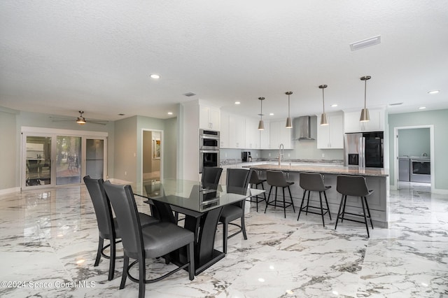 dining space with ceiling fan and a textured ceiling