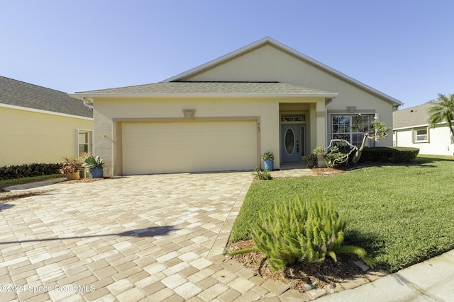 view of front of property with a front lawn and a garage