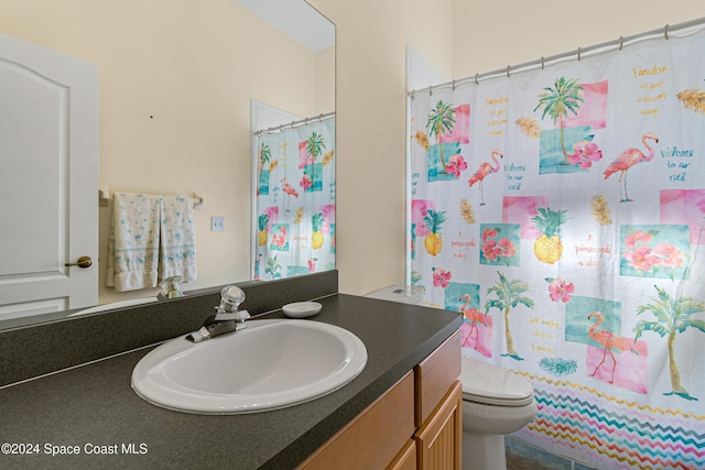 bathroom featuring walk in shower, vanity, and toilet