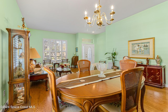 dining area featuring a chandelier and light wood-type flooring