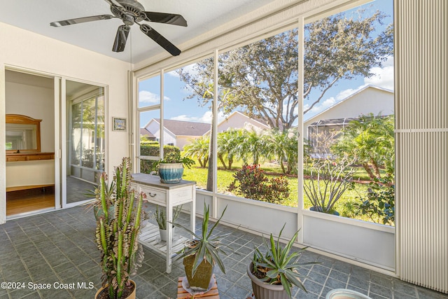 sunroom featuring ceiling fan