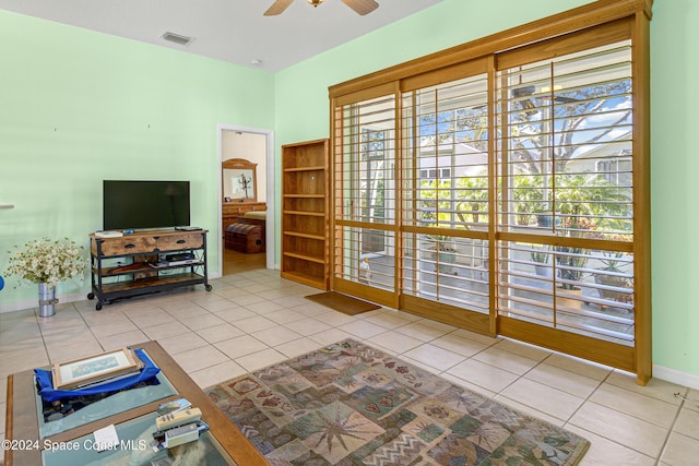 tiled living room with ceiling fan