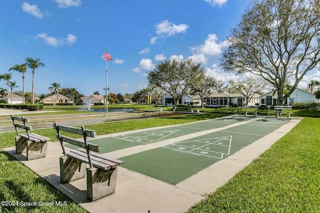 view of home's community with a yard