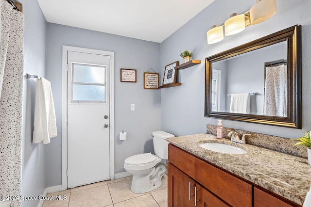 bathroom featuring tile patterned flooring, vanity, and toilet