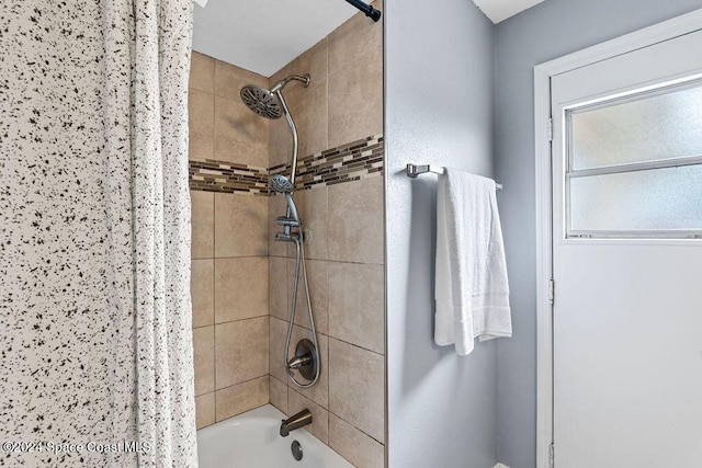 bathroom with shower / bath combo with shower curtain