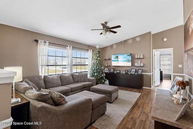 living room featuring wood-type flooring, vaulted ceiling, and ceiling fan