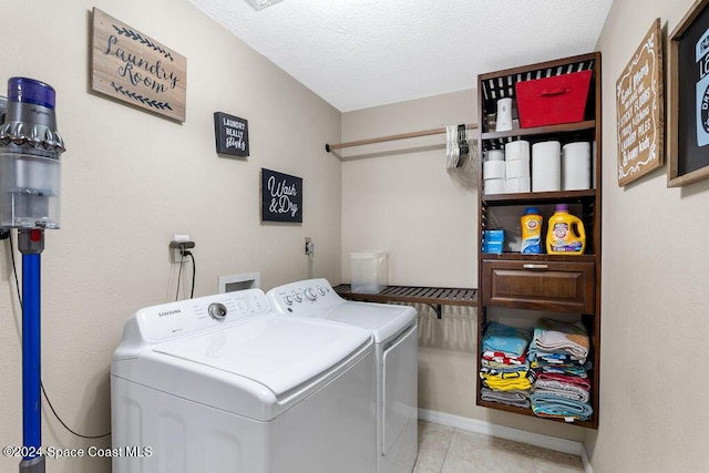 washroom with separate washer and dryer and a textured ceiling