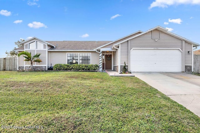 ranch-style home featuring a front lawn and a garage