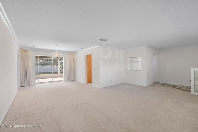 carpeted spare room with crown molding, a textured ceiling, and a notable chandelier