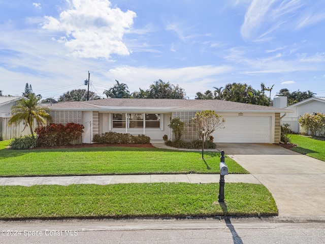 single story home with a front yard and a garage