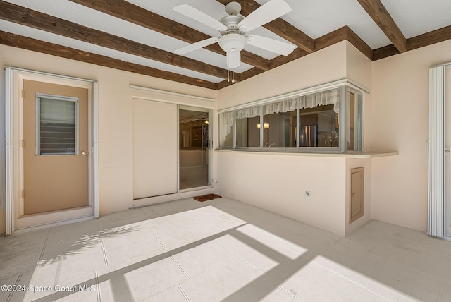 interior space with beamed ceiling and ceiling fan