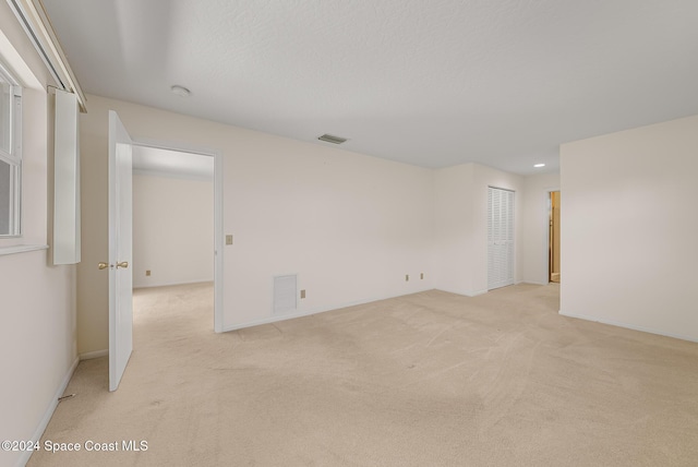 unfurnished room with light colored carpet