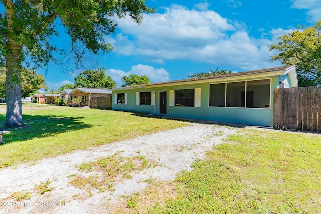 ranch-style home with a front lawn