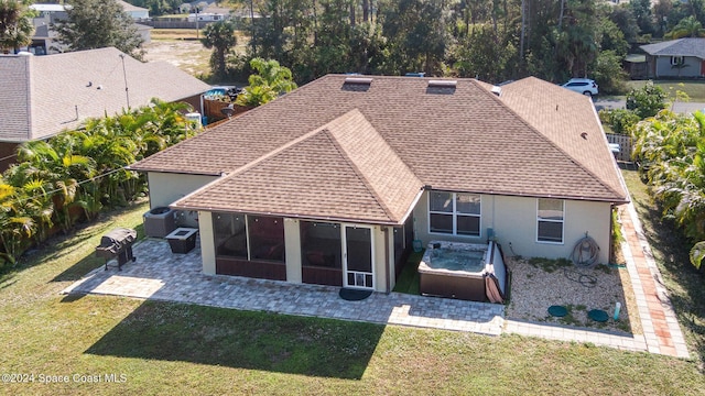 back of house with a sunroom, a yard, and a patio