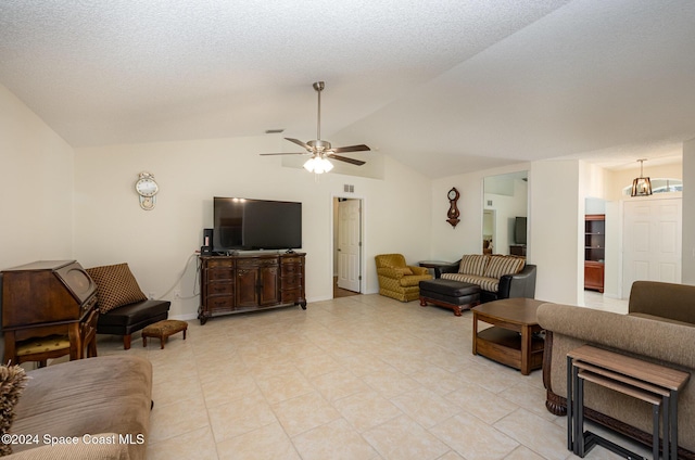 living room featuring vaulted ceiling, ceiling fan, and light tile patterned flooring