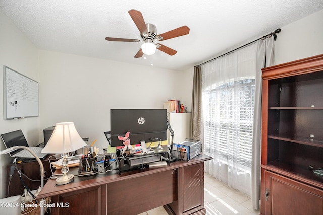 tiled home office featuring ceiling fan and a textured ceiling