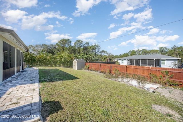 view of yard featuring a patio and a shed