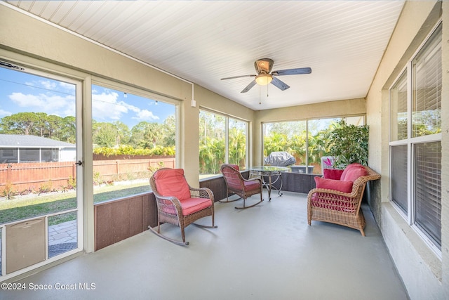 sunroom featuring ceiling fan