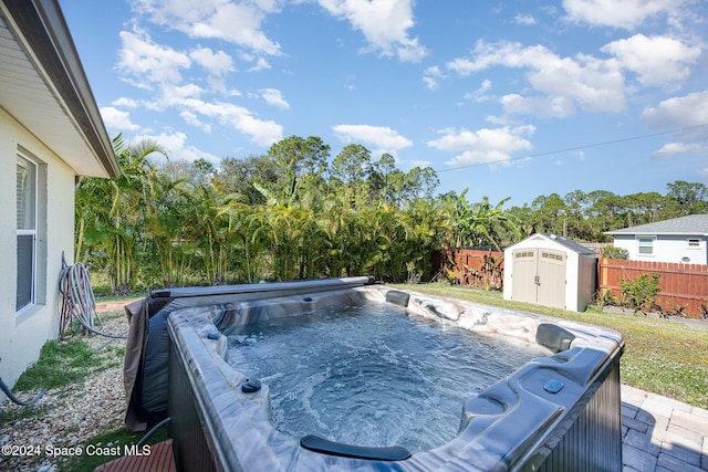 exterior space with a hot tub and a storage unit