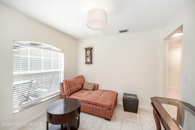 sitting room with light tile patterned flooring and a textured ceiling