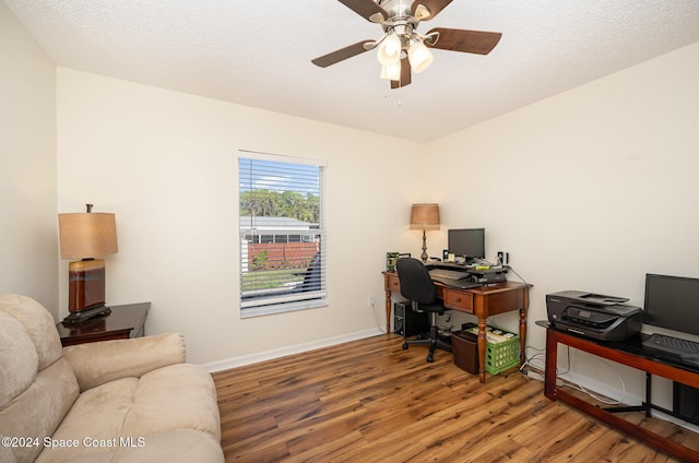 home office with a textured ceiling, hardwood / wood-style flooring, and ceiling fan