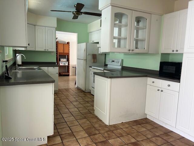 kitchen featuring white appliances, white cabinetry, ceiling fan, and sink