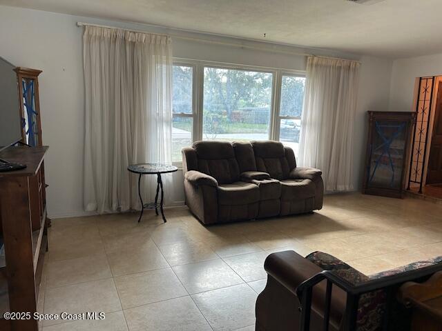 tiled living room with a healthy amount of sunlight