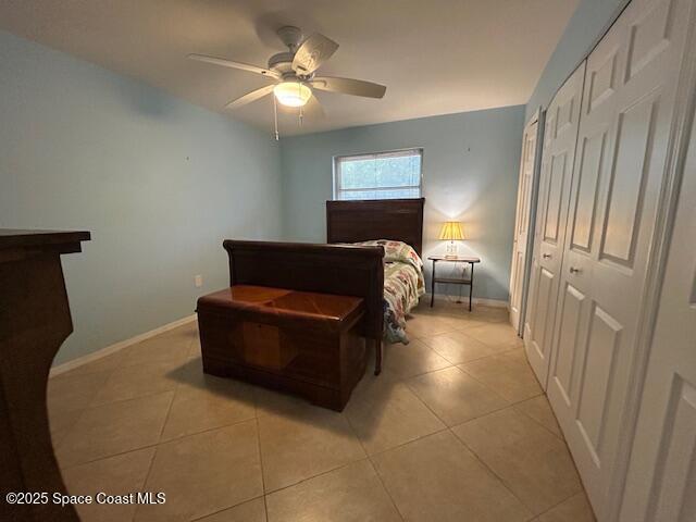 bedroom with ceiling fan, a closet, and light tile patterned flooring