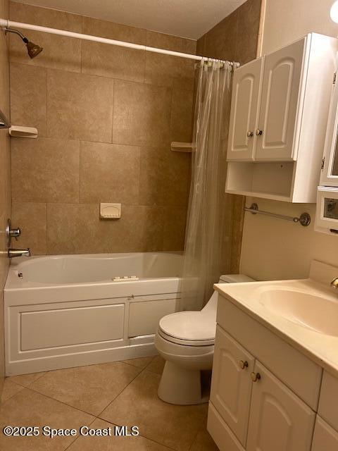 full bathroom featuring tile patterned flooring, shower / bath combination with curtain, vanity, and toilet