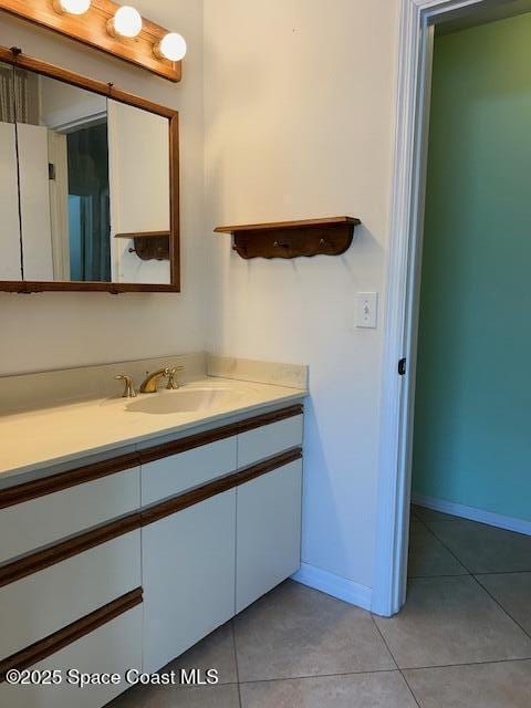 bathroom with tile patterned flooring and vanity