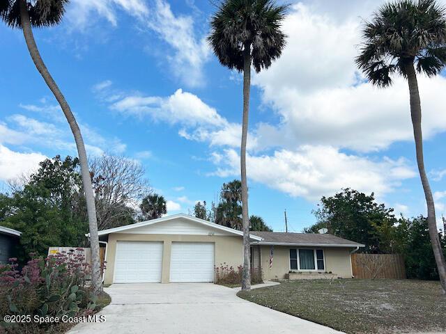 ranch-style home featuring stucco siding, driveway, an attached garage, and fence